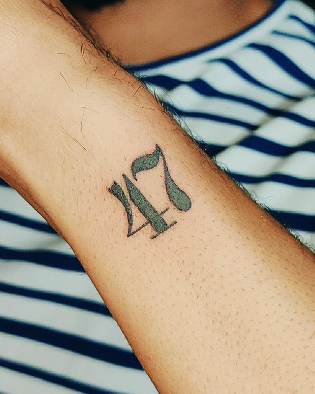 number 47 arm tattoo