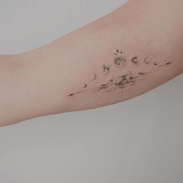 phases of the moon tattoo in the forearm 