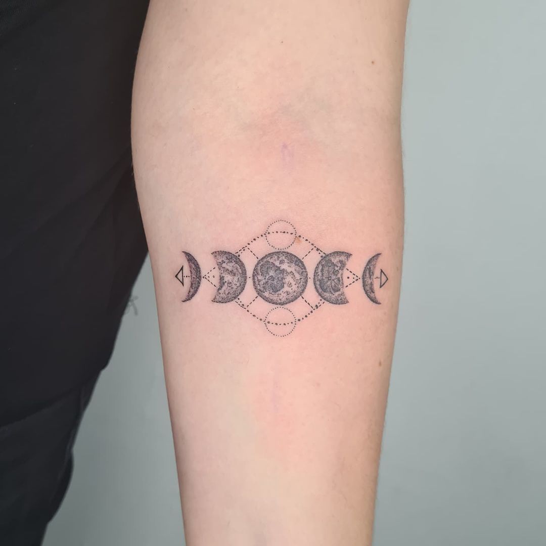 phases of the moon tattoo in the forearm