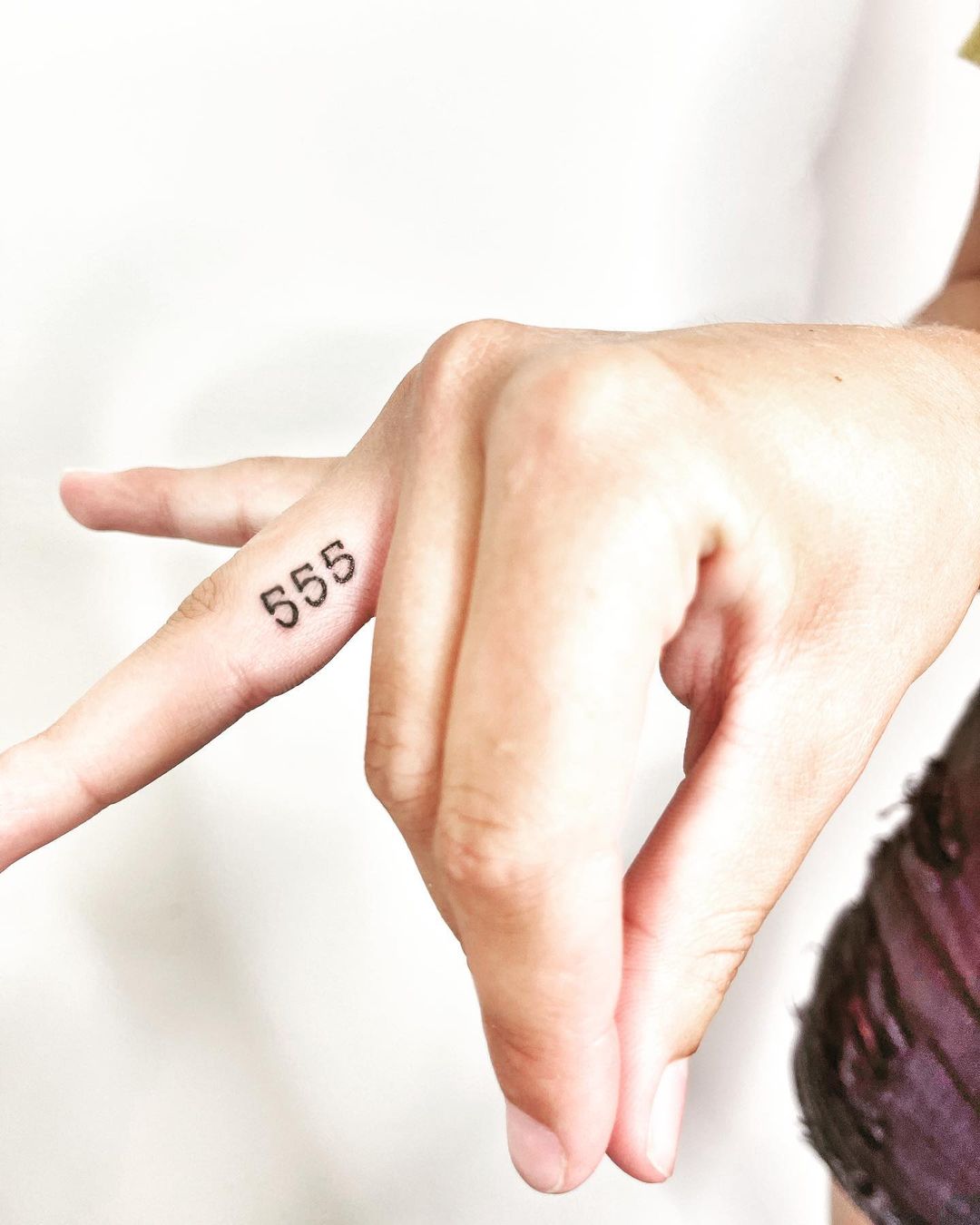 555 tattoo on the finger