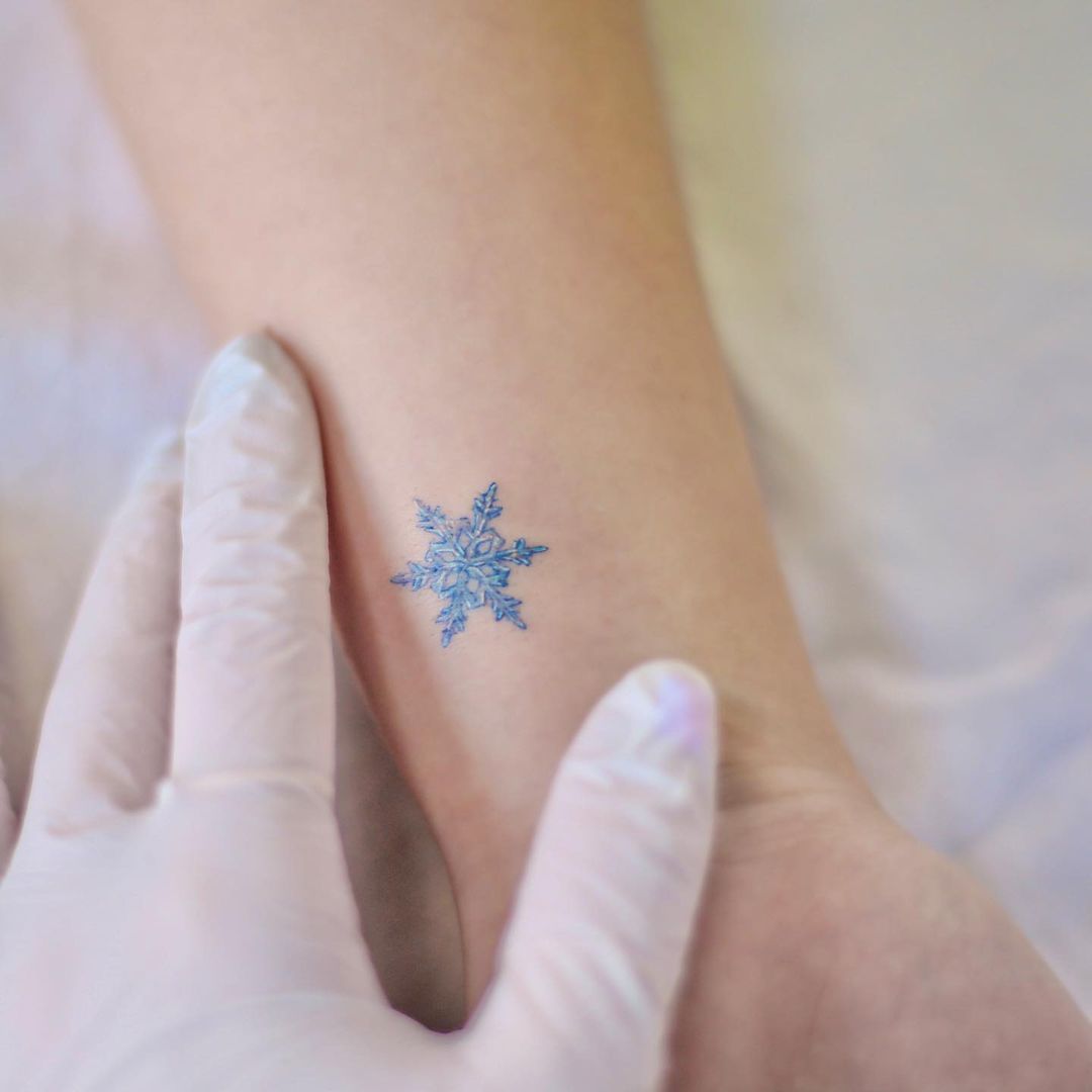 Snowflake arm tattoo