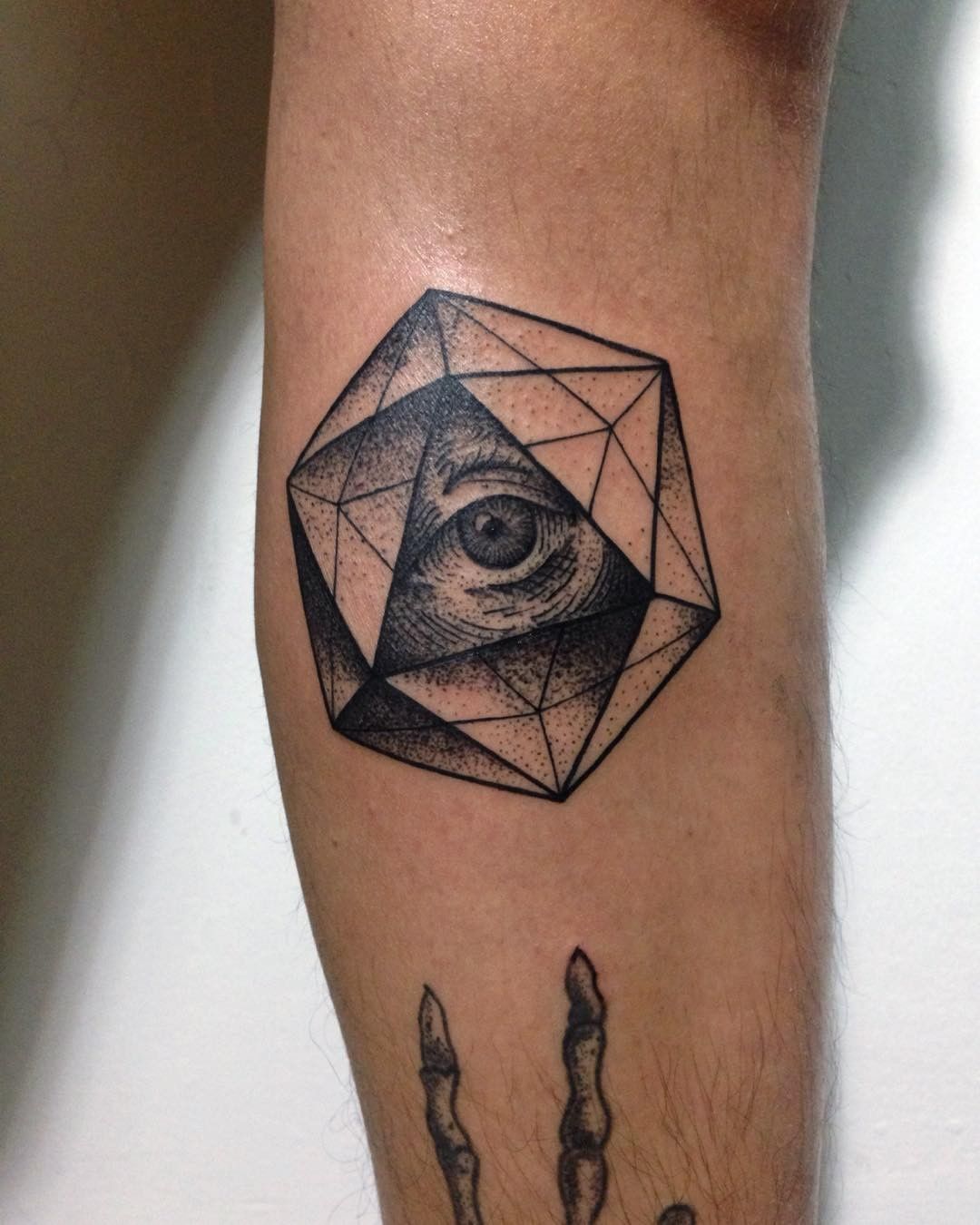 Icosahedron arm tattoo with an eye