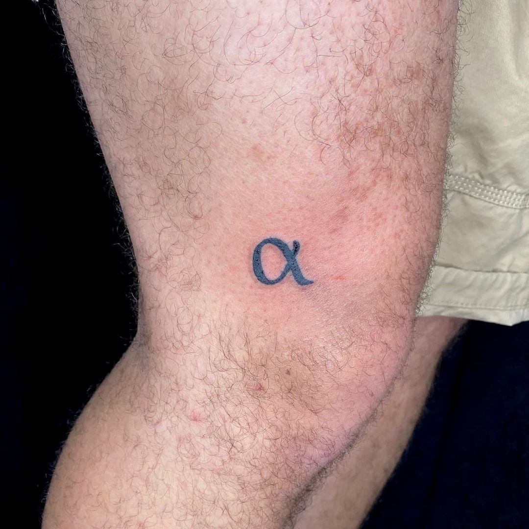alpha tattoo in the knee