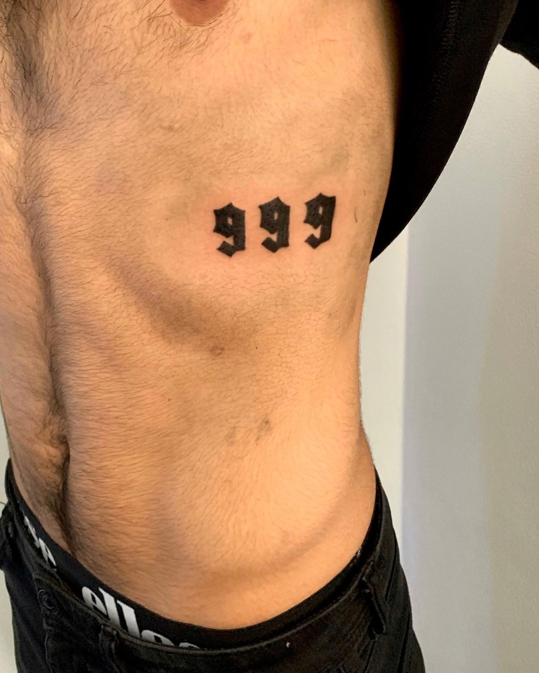 999 rib tattoo