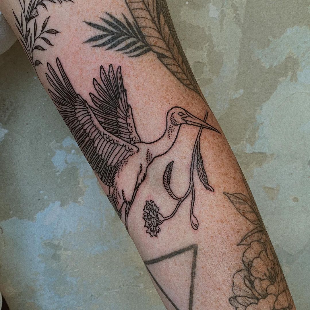 Stork arm tattoo