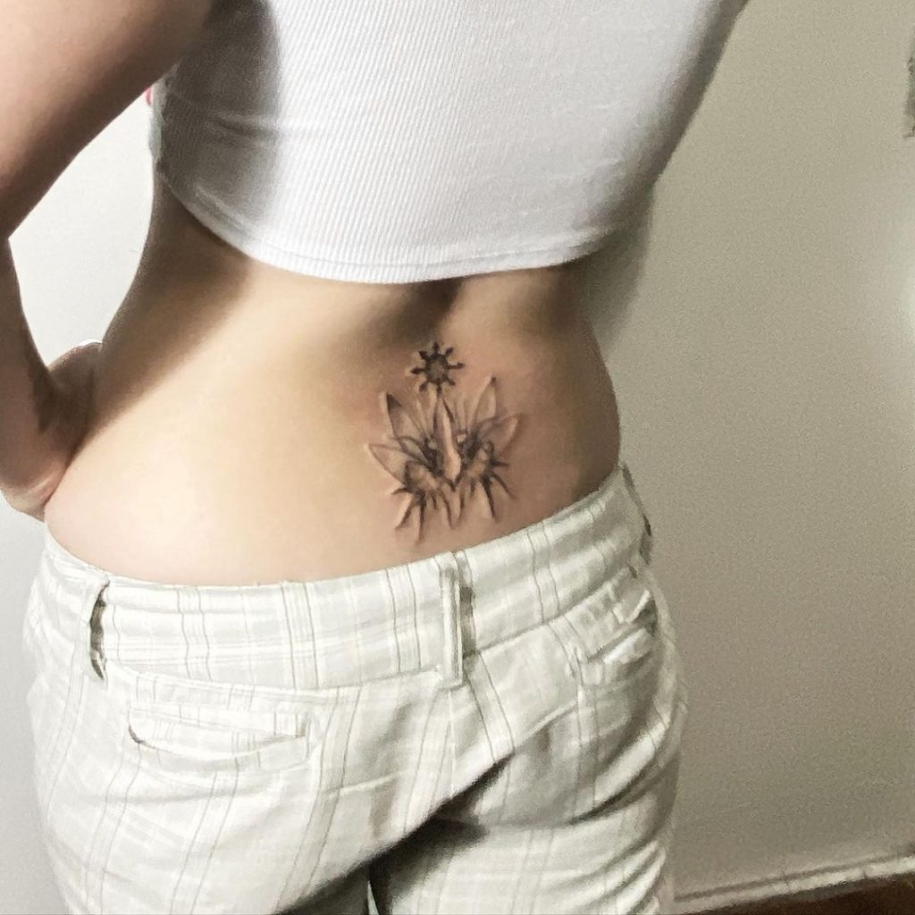 mantis tattoo in the lower back of a woman