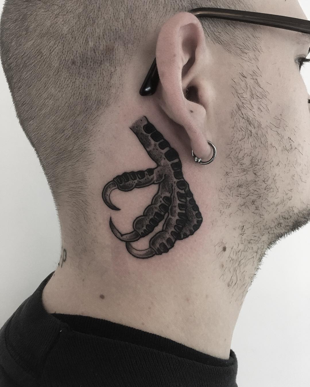 Claw behind the ear tattoo