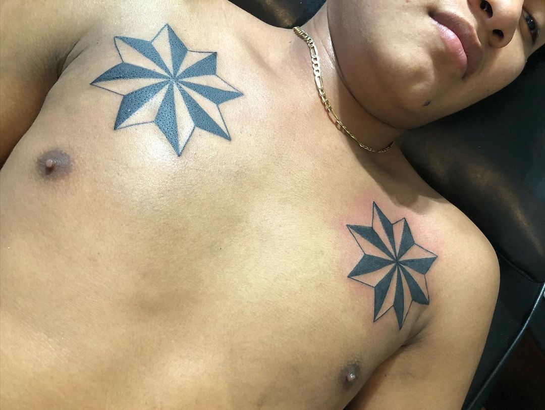 Eight point star chest tattoo