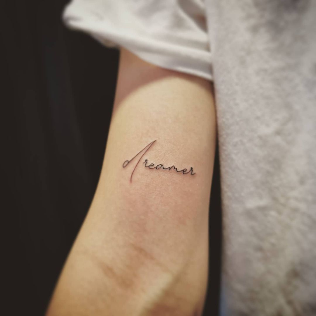 "dreamer" arm tattoo 