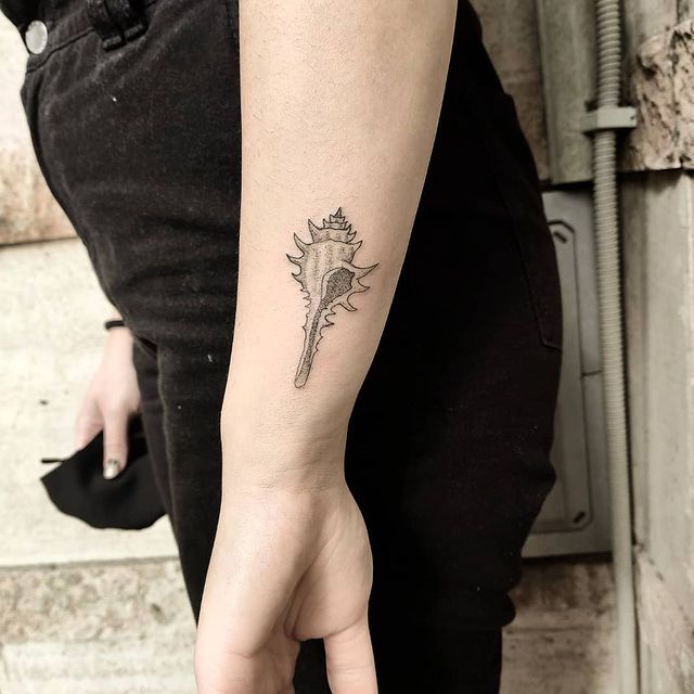 seashell arm tattoo