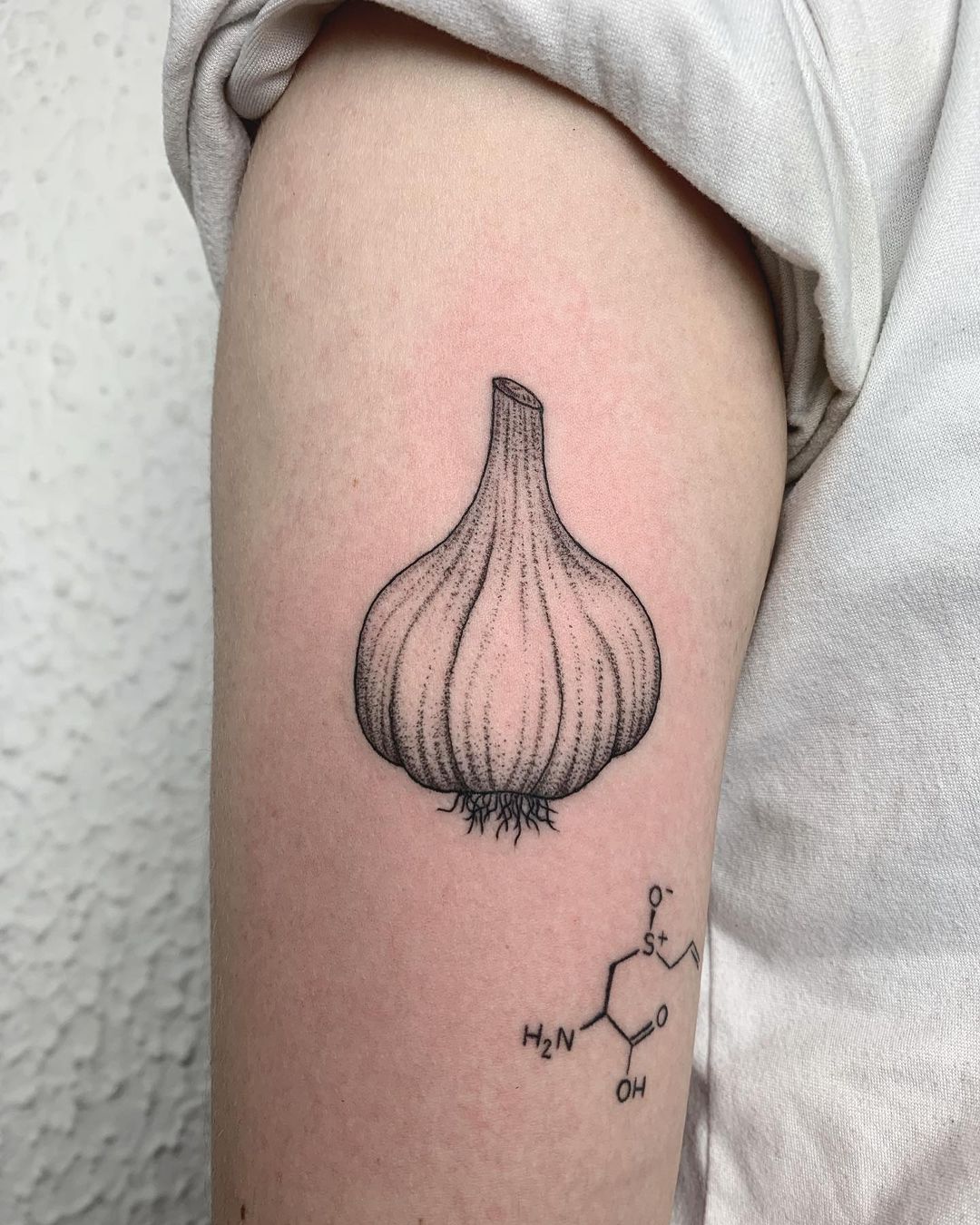 garlic tattoo on the arm