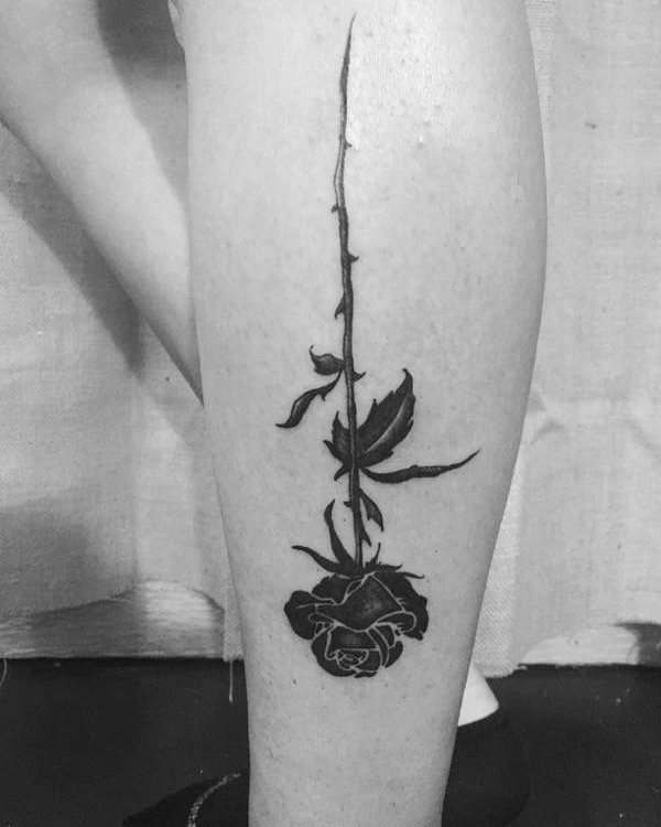 Upside down rose leg tattoo