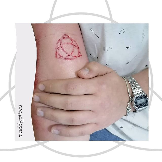 red triquetra arm tattoo