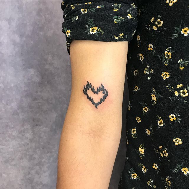 burning heart arm tattoo 