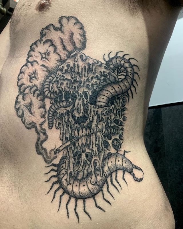 Centipede and skull tattoo