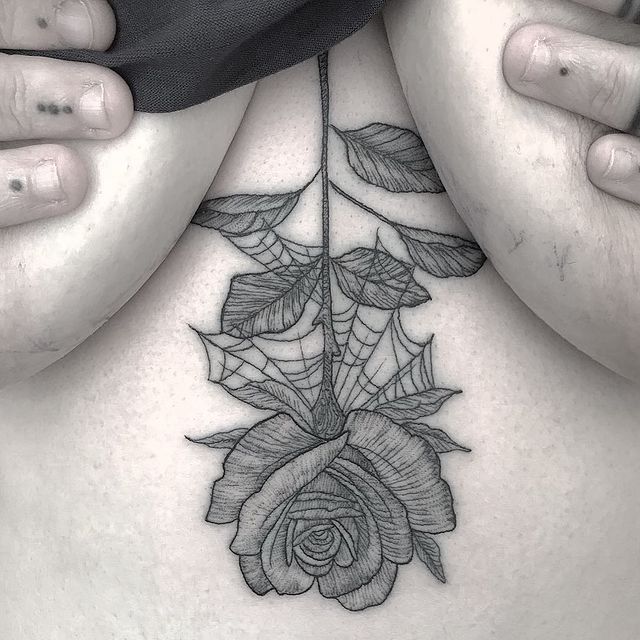 Upside down rose chest tattoo 