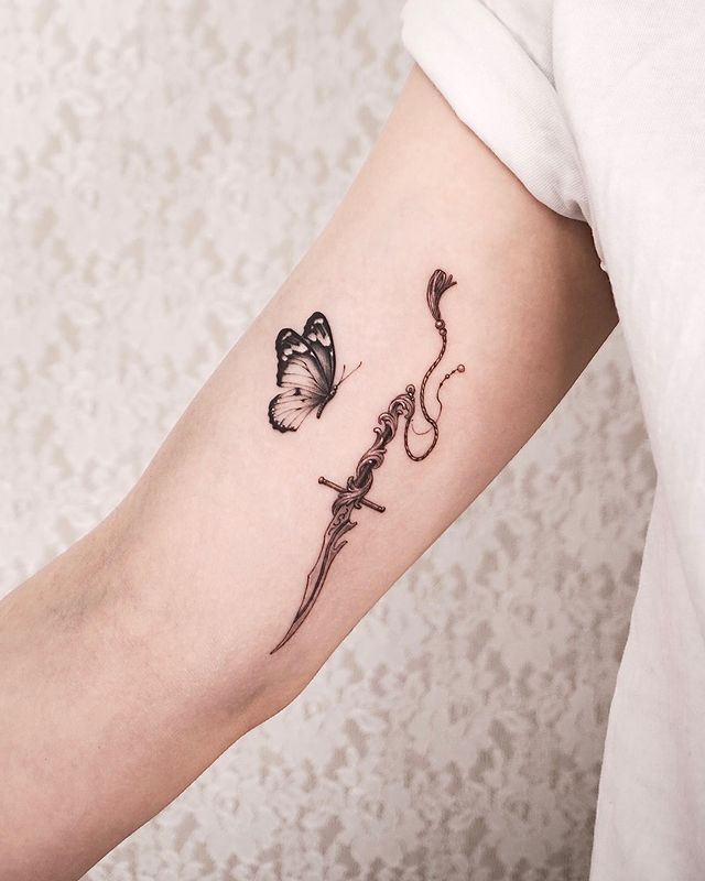 Butterfly and Dagger arm Tattoo