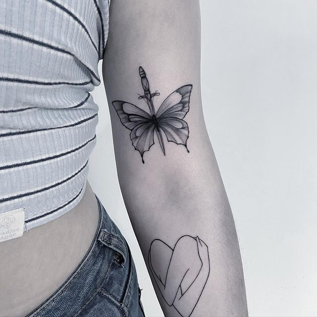 Feminine Butterfly and Dagger arm Tattoo