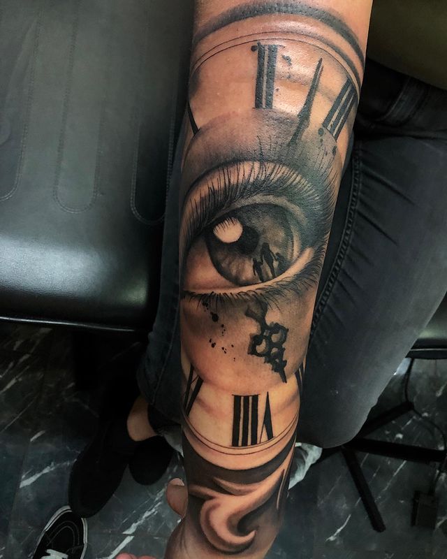 Eye and clock tattoo