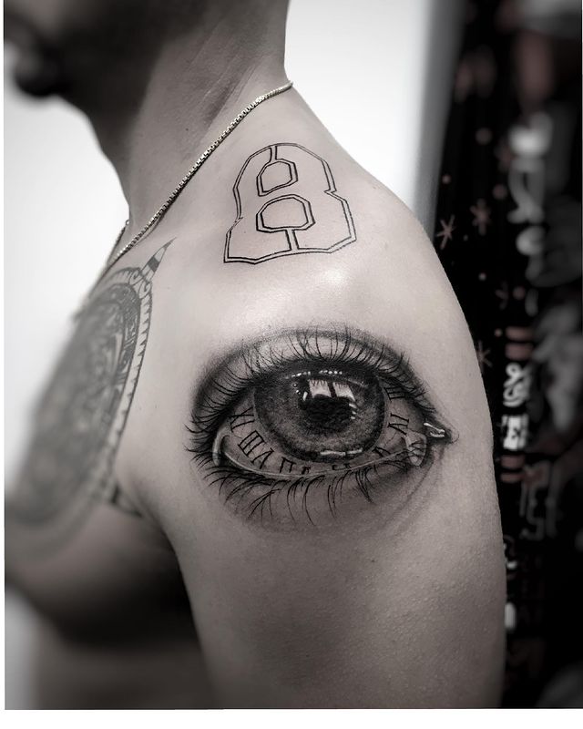 Eye and clock shoulder tattoo