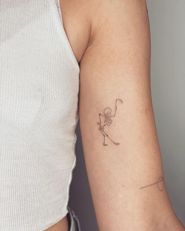 Dancing skeleton arm tattoo