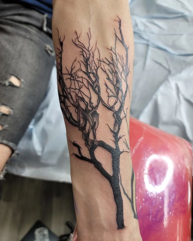 dead tree arm tattoo