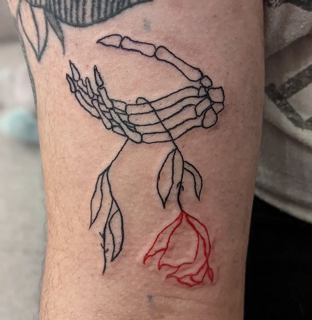 Skeleton Hand Holding a Dead Flower Tattoo