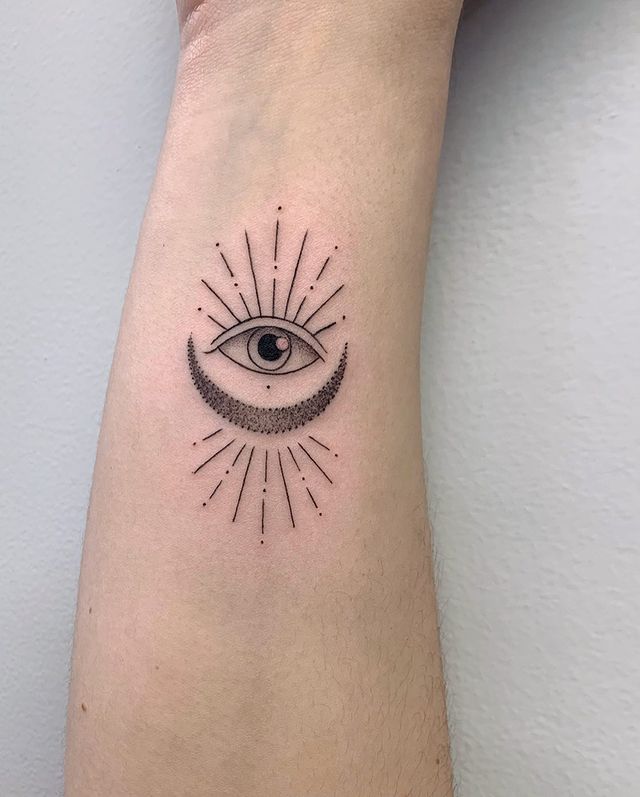 Sun moon eye tattoo