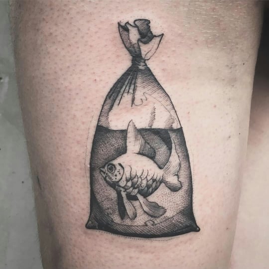 Realistic big fish in a bag tattoo