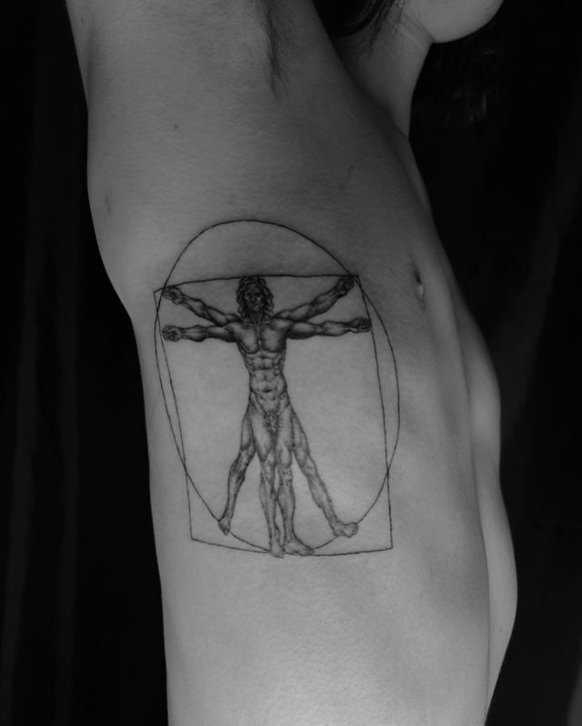 Virtruvian Man rib Tattoo