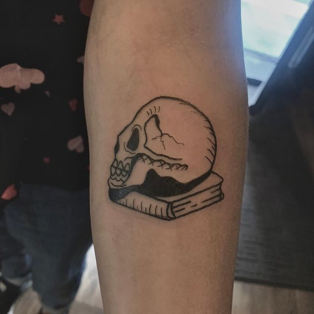 skull on book tattoo